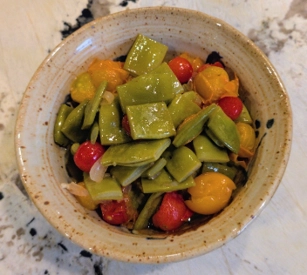 Bowl of italian flat beans with smashed cherry tomatoes