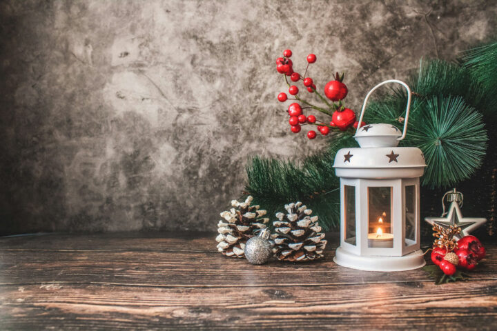 Holiday Decor Art showing a lantern, pine cones and tree decorations.